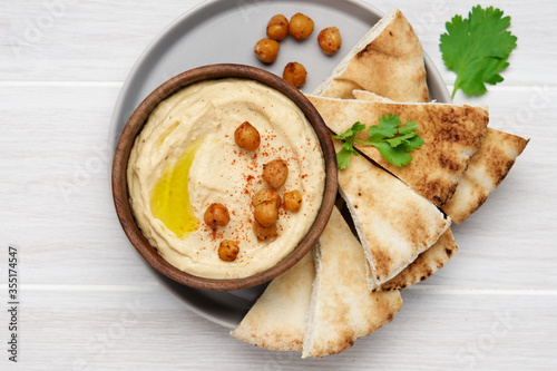 Hummus plate with pita bread. Middle Eastern traditional appetiser. Authentic arab cuisine photo