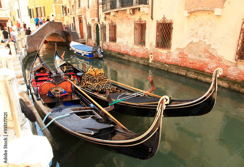 Gondolas in a small canal in Venice, Italy.