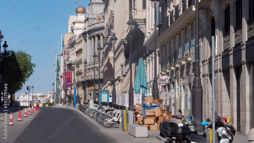 Madrid, Spain.june 02, 2020.CARDBOARD BOXES STACKED FOR RECYCLING, NEXT TO A BICYCLE SHARING IN ALCALA STREET, MADRID