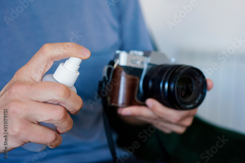 man disinfecting his camera © nito