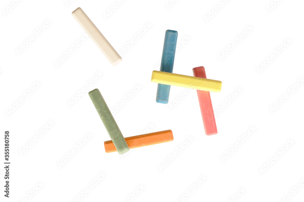 Obraz premium Colorful chalk clustered together lying flat on a blank white isolated background