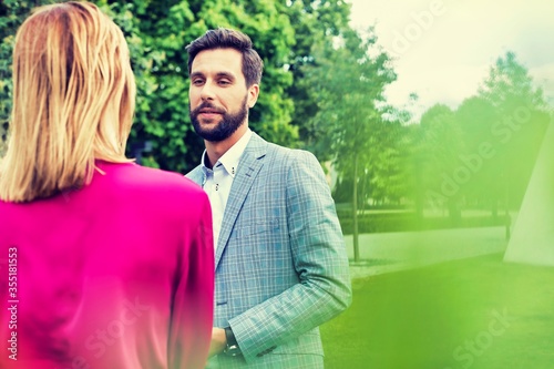 Businessman discussing plans with businesswoman on meeting outdoor 