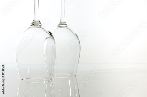 Two inverted glasses for wine with reflection