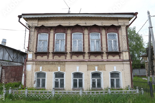 House in Filimonovo, May 1 street, Pavlovsky Posad town, Moscow region, Russia. Vintage wooden building facade with ornamental carved windows. Russian folk style in architecture. Pavlovsky Posad sight photo