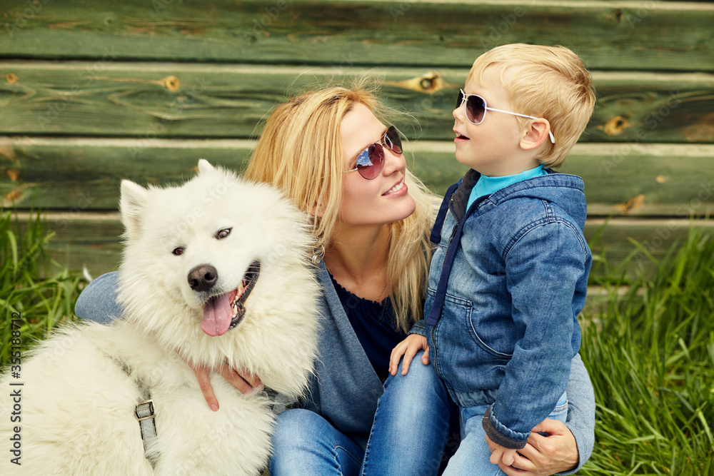 outdoor portrait mother, son and dog. child and mom walking samoyed laika. outdoor portrait mother, son and dog. child and mom walking samoyed laika.