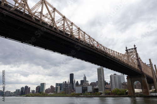 Queensboro Bridge along the East River with the Midtown Manhattan Skyline in New York City on a Cloudy Day © James