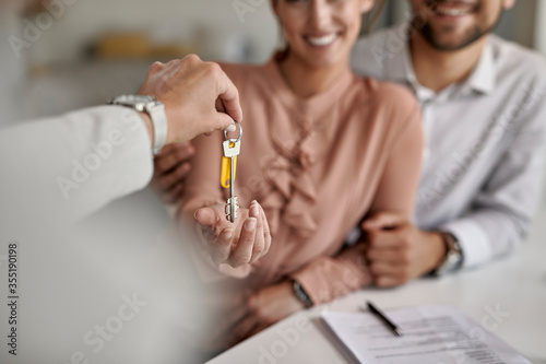 Close-up of a couple receiving new house keys.