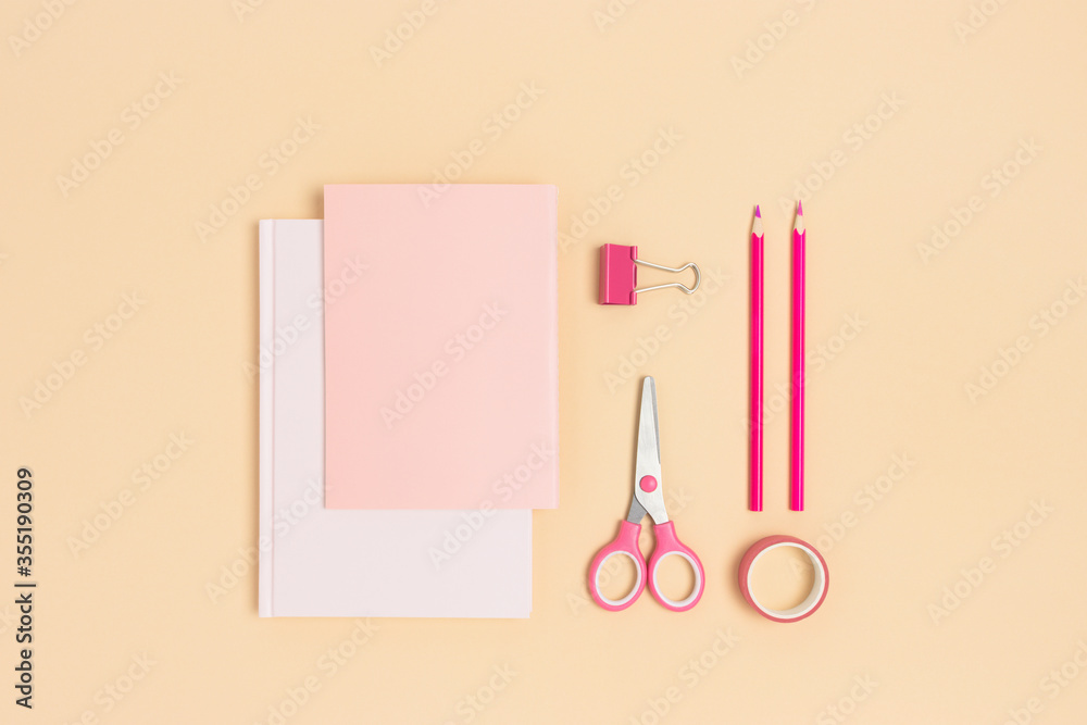 Set of pink school supplies on a beige background. Office stationery concept. Set of pink school supplies on a beige background. Office stationery concept.