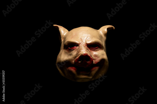 Scary pig mask isolated on black background. Bloody horror mask. Halloween concept.