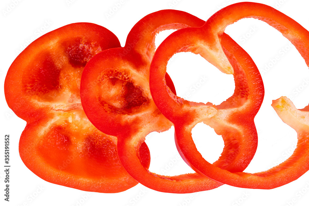 Macro photography of juicy red bell pepper cut up slices and isolated on white background. Fresh vegetable, healthy food