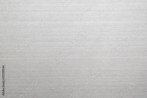 Abstract metal texture of brushed stainless steel plate with the reflection of light.