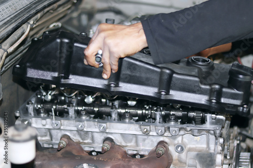 auto mechanic changing car engine