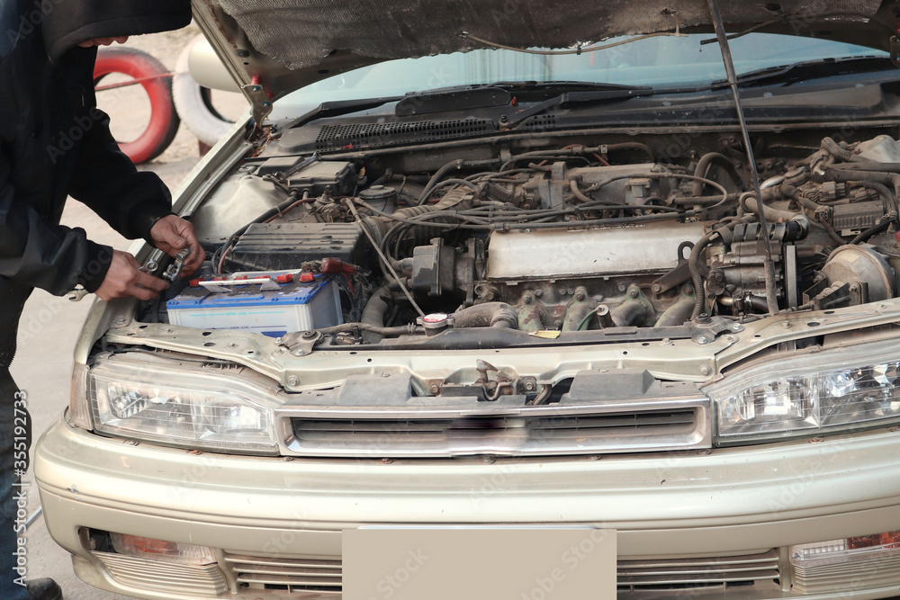 Fototapeta premium auto mechanic changing car engine