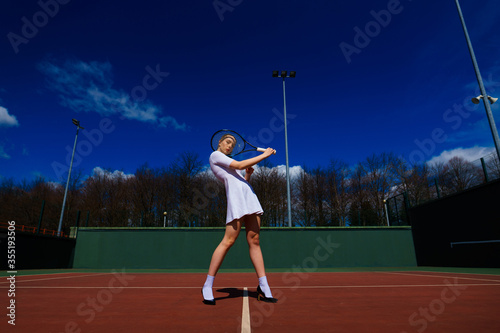 Happy beautiful sexy girl playing tennis on the court. Sport and recreation, leisure © Ivan Zelenin
