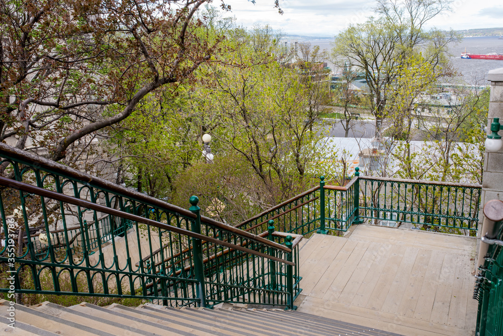 Stairs in Quebec, Canada, lead down to level of the river in the background.