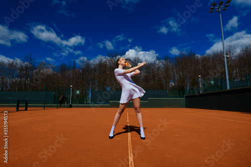 Happy beautiful sexy girl playing tennis on the court. Sport and recreation, leisure © Ivan Zelenin