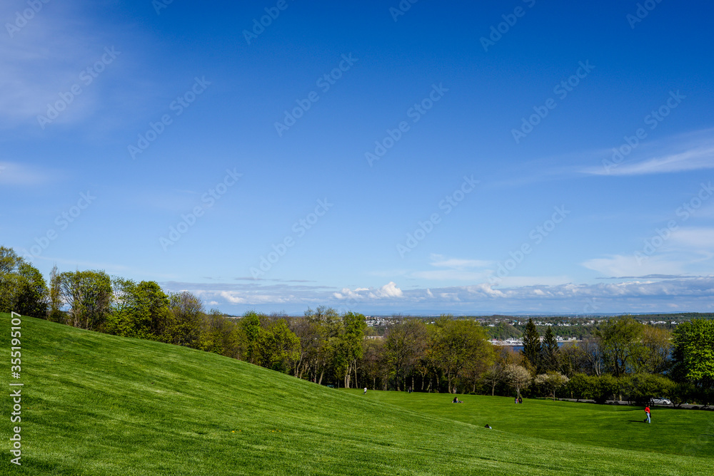 Rolling grassy hills in Battlefields Park with a view overlooking Quebec, Canada.