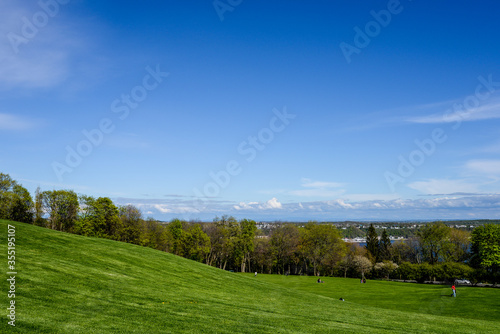 Rolling grassy hills in Battlefields Park with a view overlooking Quebec, Canada.