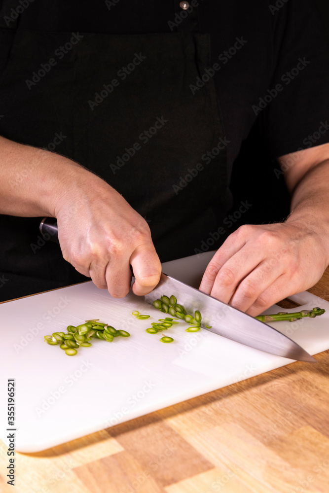 Fototapeta premium female hands cutting asparagus