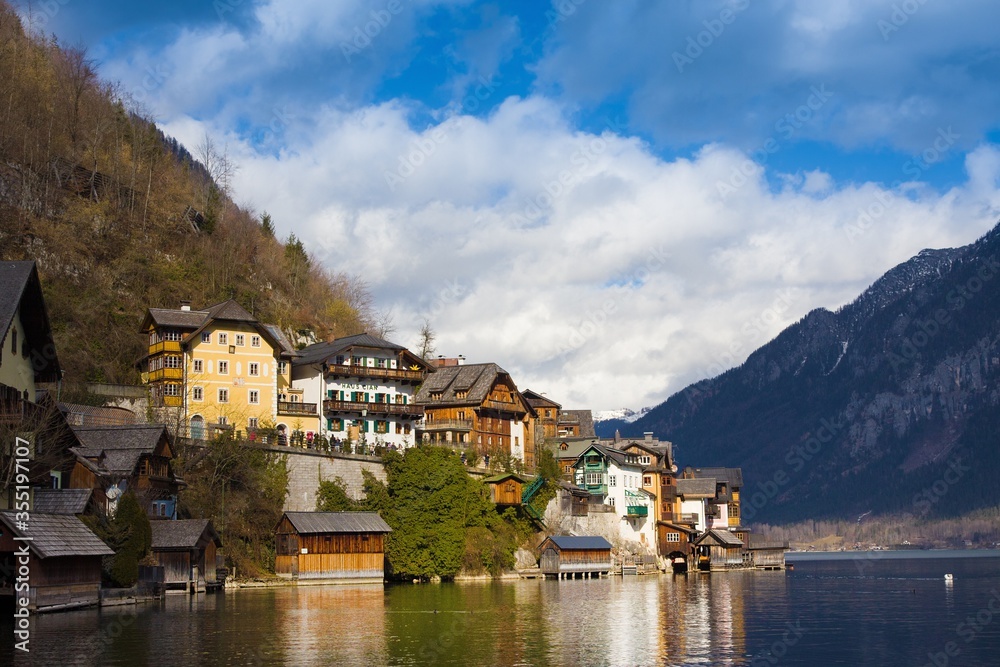 Beautiful view of houses on mountains around Hallstatt - small historical village. UNESCO world heritage site, old European architecture. It is famous tourist attraction