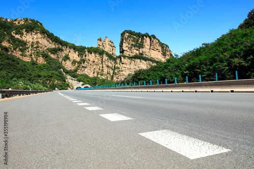 Empty highway, blue sky and white clouds landscape