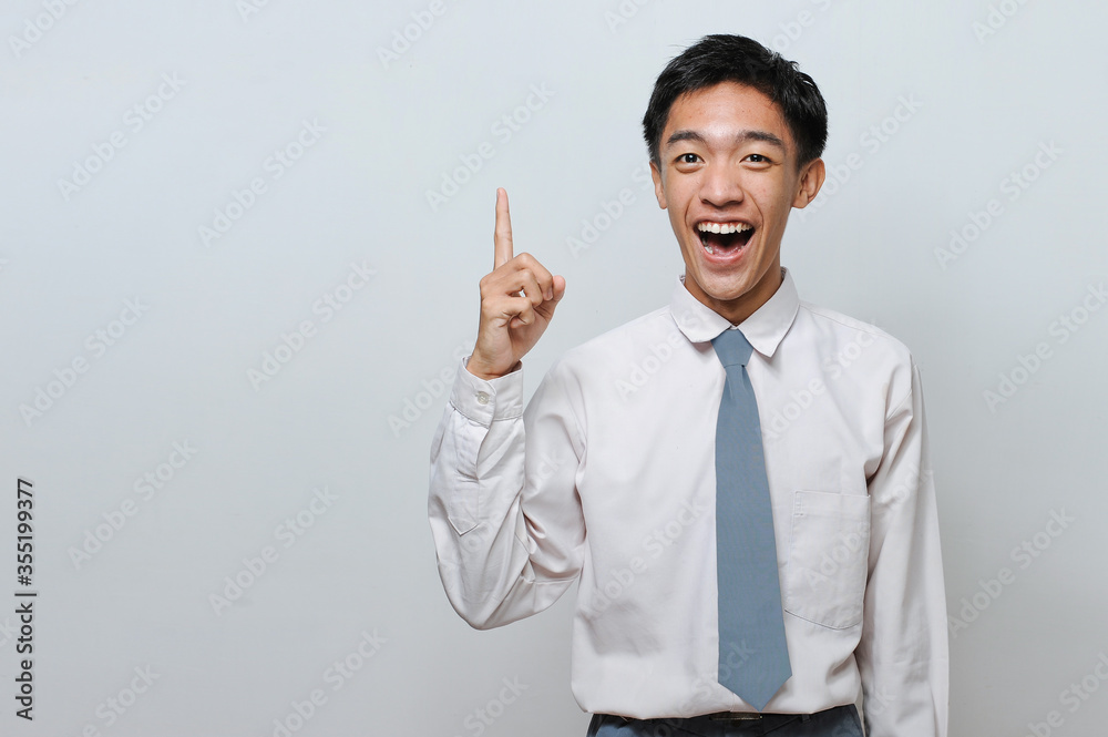 Indonesian Student wearing senior high school uniform with success gesture getting the best idea Indonesian Student wearing senior high school uniform with success gesture getting the best idea