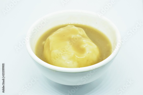 mashed potato dressing gravy sauce in cup on white background