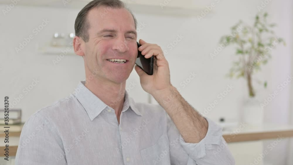 Portrait of Cheerful Middle Aged Man Talking on Smartphone Portrait of Cheerful Middle Aged Man Talking on Smartphone
