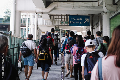 People walk along the star Ferry pier in Hong Kong photo