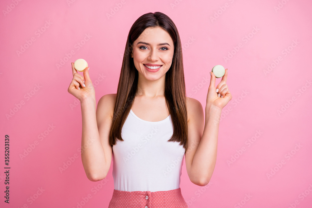 Portrait of her she nice-looking attractive lovely charming cute pretty cheerful cheery straight-haired girl holding in hands cookies counting calories isolated over pink pastel color background Portrait of her she nice-looking attractive lovely charming cute pretty cheerful cheery straight-haired girl holding in hands cookies counting calories isolated over pink pastel color background