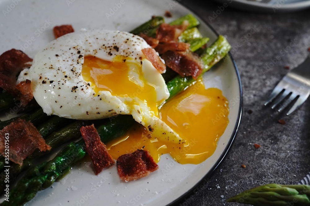 Poached egg with grilled asparagus, selective focus Poached egg with grilled asparagus, selective focus