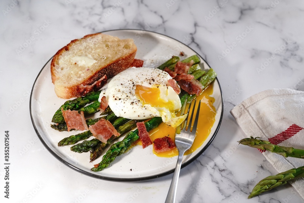 Poached egg with grilled asparagus, selective focus Poached egg with grilled asparagus, selective focus