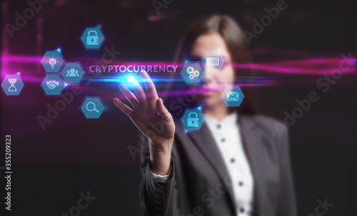 Business, Technology, Internet and network concept. Young businessman working on a virtual screen of the future and sees the inscription: Cryptocurrency