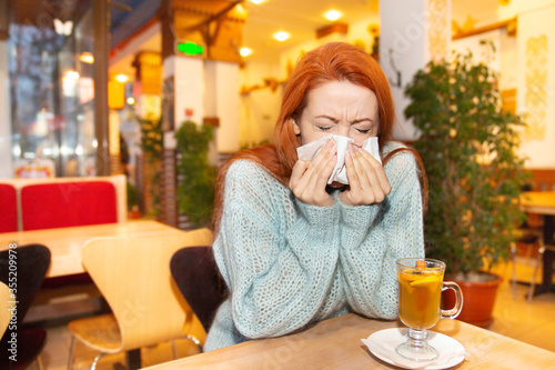 Принти на полотні Covid patient in public place. Woman with flu sneezing nose