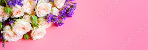 Wallpaper Mural a bouquet of cream roses and bright purple flowers in full bloom on a pink background with space for text. greeting card. banner Torontodigital.ca