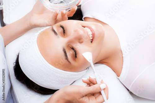 Face peeling at the beautician. Facial treatments. Photo chemical, glycolic, almond peeling.