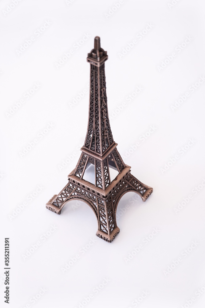 Eiffel Tower on an isolated white background. Old metal figurine.