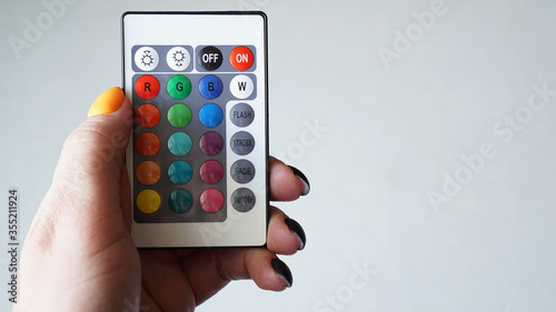 Wallpaper Mural Remote control for change colors in hand isolated on white background Torontodigital.ca