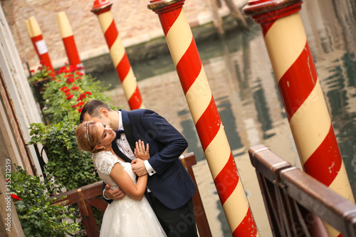 Beautiful wedding couple posing near dock in venice