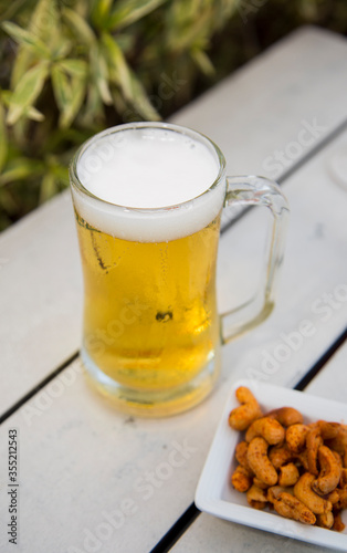 glass of beer and peanut snack
