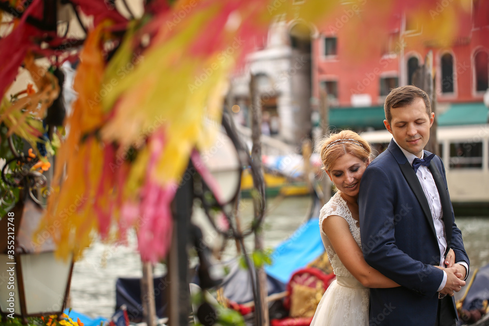 Beautiful wedding couple posing in city street