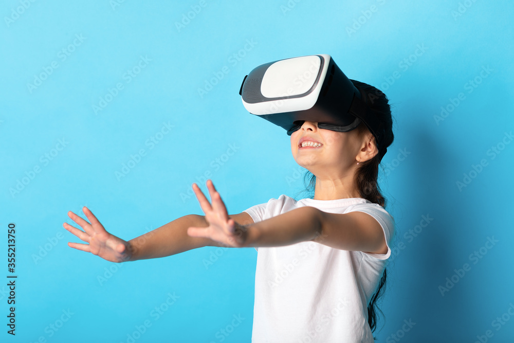 Girl wearing virtual reality goggles at the studio Girl wearing virtual reality goggles at the studio