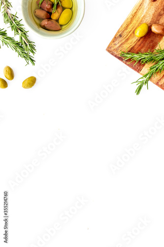 Fototapeta Naklejka Na Ścianę i Meble -  Green olives with oil on kitchen table. Top view 