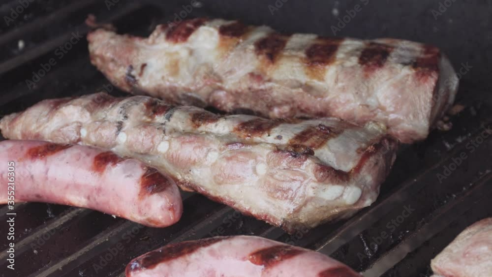 Barbecue grill with grilled pork ribs and criollo sausage. Spanish churrasco