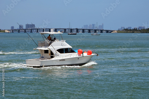 White sport fishing boat with sedan bridge on the Florida Intra-Coastal Waterway off of Miami Beach.