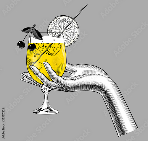 Female hand holding a glass with a fruit cocktail