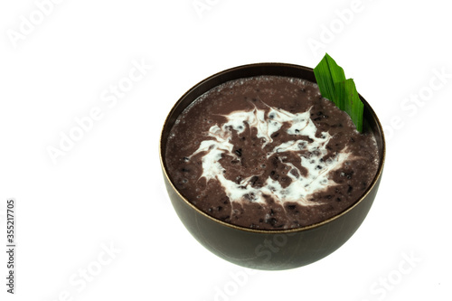 Black Glutinous Rice Porridge or Bubur Pulut Hitam in Malay with coconut milk on white background