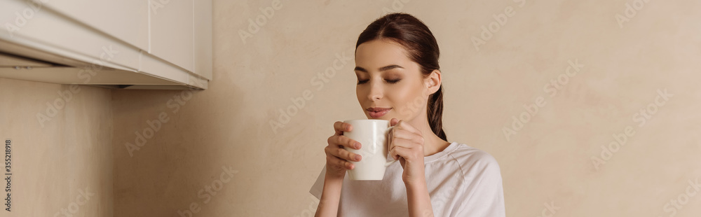 panoramic concept of girl smelling coffee while holding cup panoramic concept of girl smelling coffee while holding cup