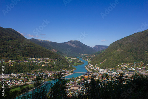 View of a mountain valley with a river below and houses. Norway. Otta