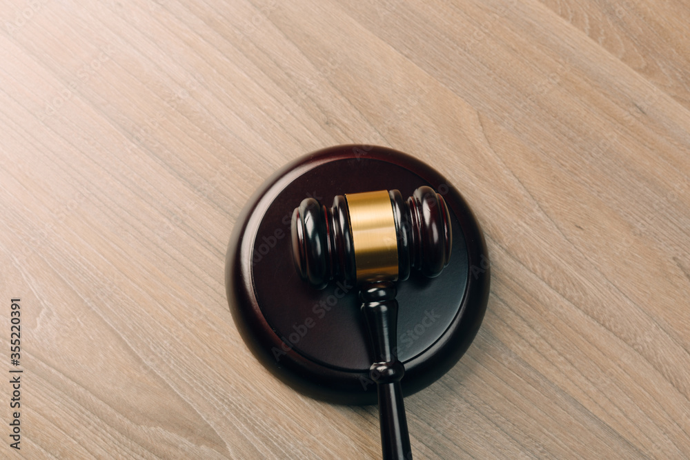 Symbol of law and justice on wooden table in lawyer office Symbol of law and justice on wooden table in lawyer office
